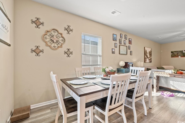 dining room with light hardwood / wood-style flooring and ceiling fan