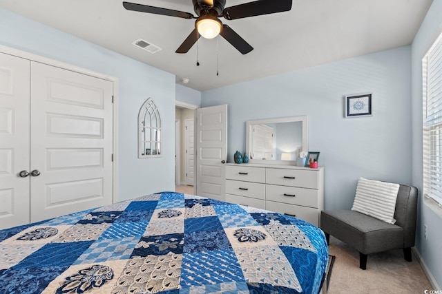 carpeted bedroom with a closet and ceiling fan