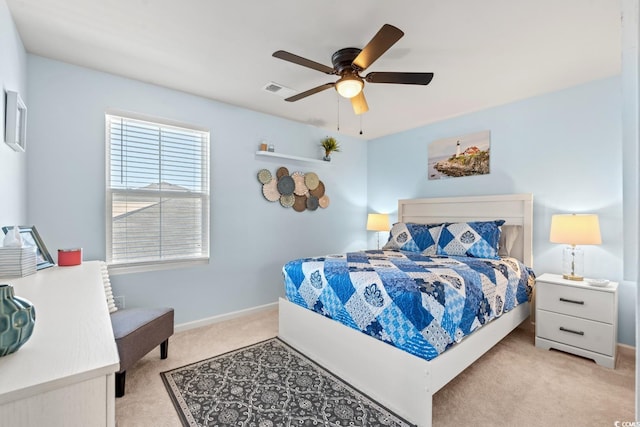 bedroom featuring ceiling fan and light carpet