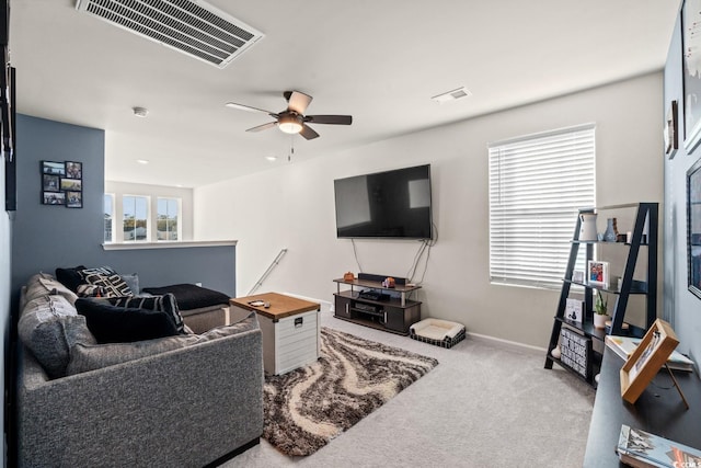 living room featuring ceiling fan, light colored carpet, and plenty of natural light