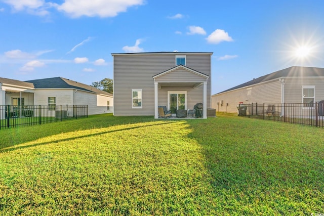 rear view of house featuring a lawn