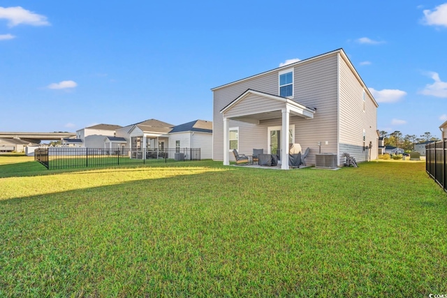 rear view of property with a lawn and a patio area