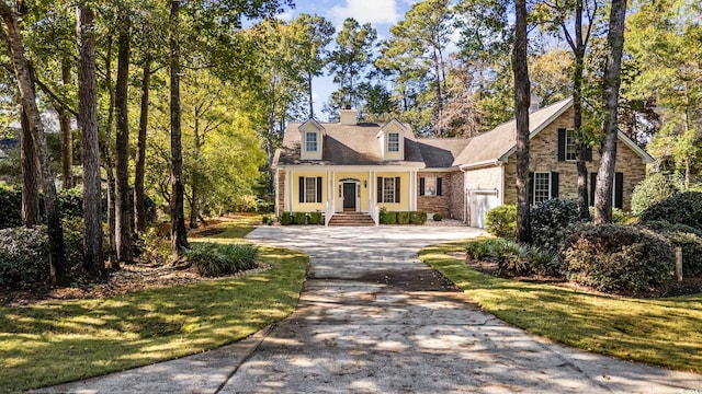 cape cod-style house with a porch and a front yard