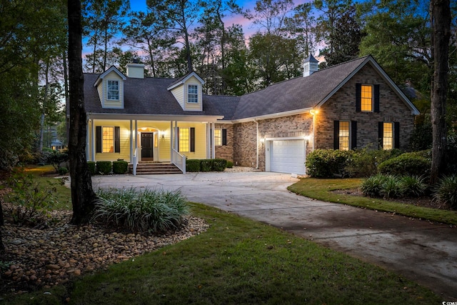 new england style home with a garage and a lawn