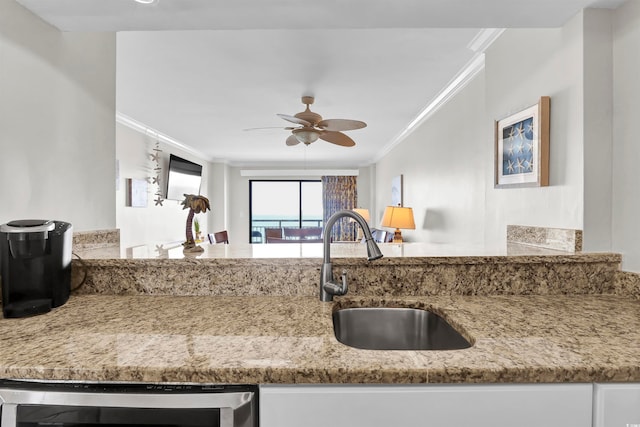 kitchen featuring wine cooler, crown molding, sink, and ceiling fan