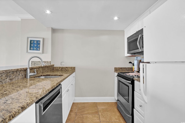 kitchen with white cabinets, stone countertops, stainless steel appliances, and sink