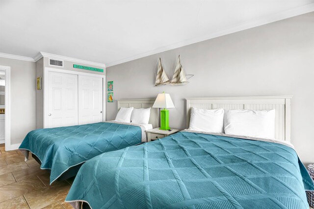 bedroom with a closet and ornamental molding