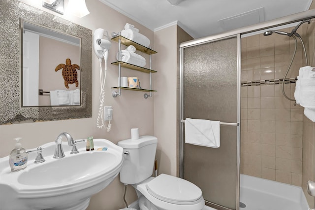 bathroom featuring toilet, walk in shower, ornamental molding, and sink