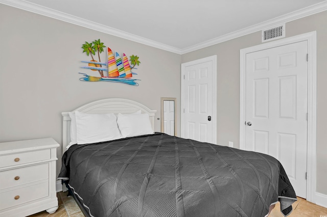 bedroom with light tile patterned floors and ornamental molding