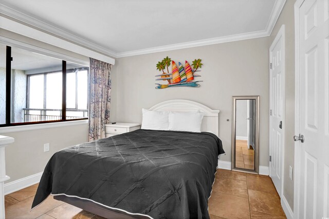 bedroom with light tile patterned floors and crown molding