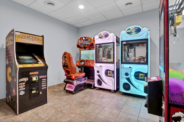 game room featuring light tile patterned floors and a paneled ceiling