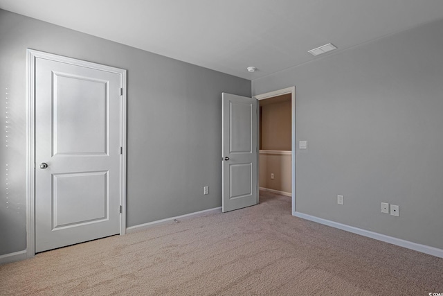 unfurnished bedroom featuring light carpet