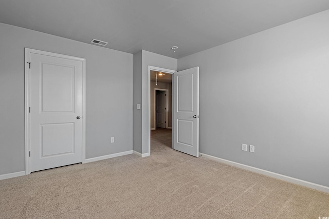 unfurnished bedroom with light colored carpet