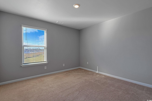 empty room featuring light colored carpet