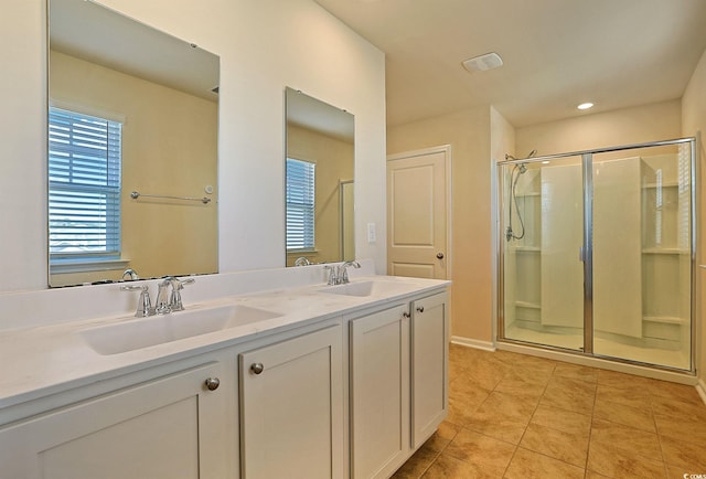 bathroom featuring tile patterned flooring, vanity, and an enclosed shower