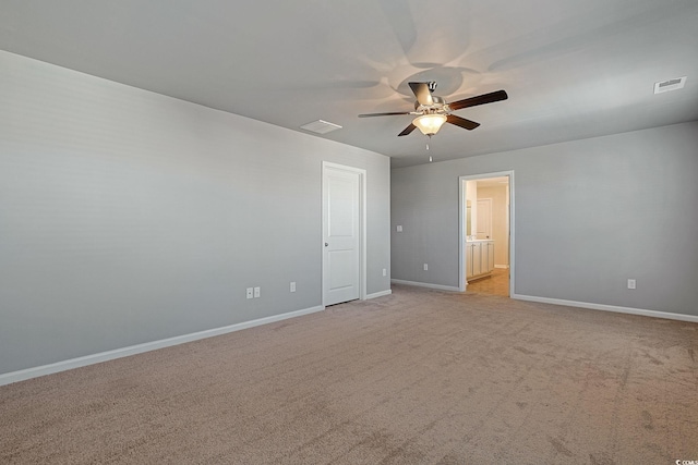 empty room with ceiling fan and light carpet