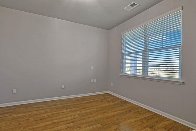 unfurnished room with hardwood / wood-style floors