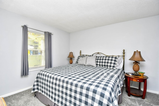 bedroom featuring carpet flooring and a textured ceiling