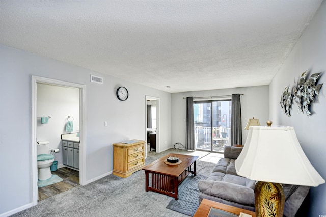 living room featuring a textured ceiling and hardwood / wood-style flooring