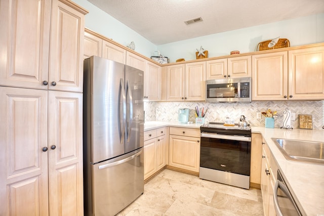 5102 Sweetwater Blvd -, Unit Murrells Inlet, SC 29576 - kitchen with appliances with stainless steel finishes, light brown cabinetry, light countertops, decorative backsplash, and a textured ceiling