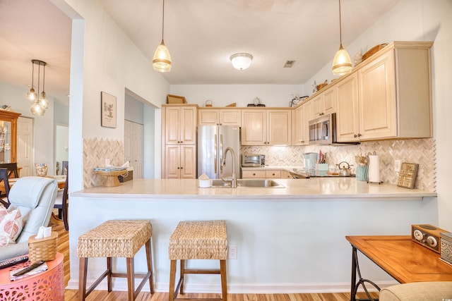 5102 Sweetwater Blvd -, Unit Murrells Inlet, SC 29576 - kitchen with stainless steel appliances, a peninsula, decorative backsplash, wood finished floors, and decorative light fixtures