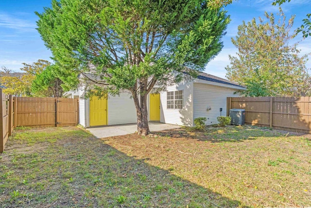 back of house featuring a lawn, a patio area, and central air condition unit