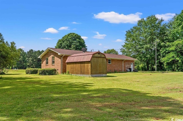 exterior space featuring a lawn and a shed