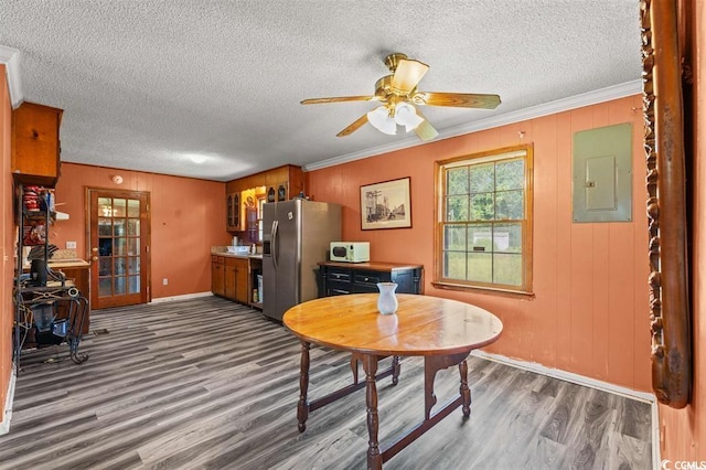 dining room with ornamental molding, a textured ceiling, electric panel, and dark wood-type flooring