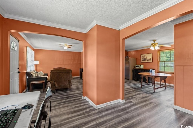 kitchen featuring stainless steel refrigerator, ceiling fan, wood-type flooring, and ornamental molding