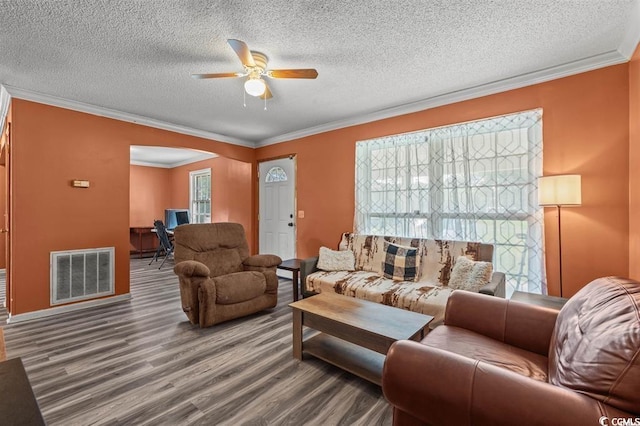 living room with hardwood / wood-style flooring, plenty of natural light, and crown molding