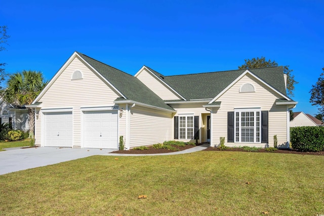 view of front of house featuring a garage and a front lawn