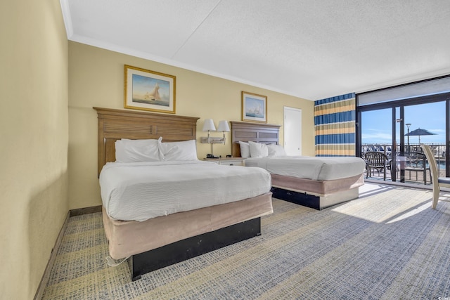 2311 S Ocean Blvd Unit 139, Myrtle Beach, SC 29577 - bedroom with access to exterior, ornamental molding, a textured ceiling, and baseboards