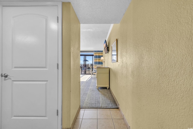 2311 S Ocean Blvd Unit 139, Myrtle Beach, SC 29577 - hallway featuring a textured wall, light tile patterned floors, and baseboards