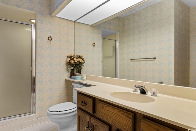 bathroom featuring tile patterned flooring, vanity, toilet, and an enclosed shower