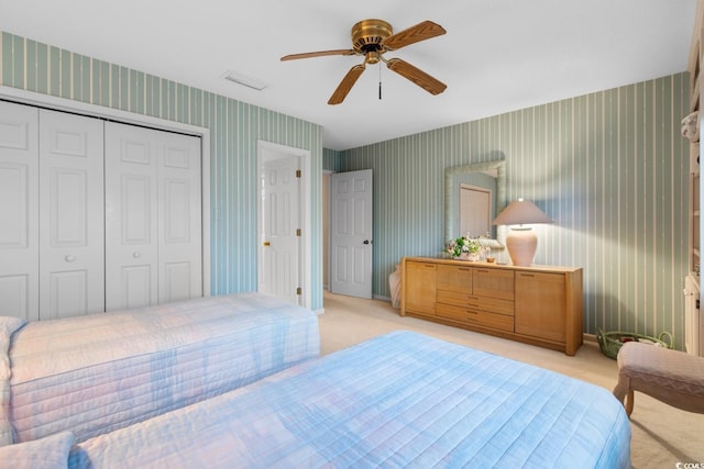 carpeted bedroom with a closet and ceiling fan