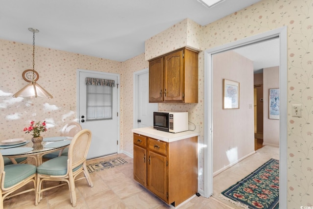 kitchen featuring light tile patterned floors and hanging light fixtures