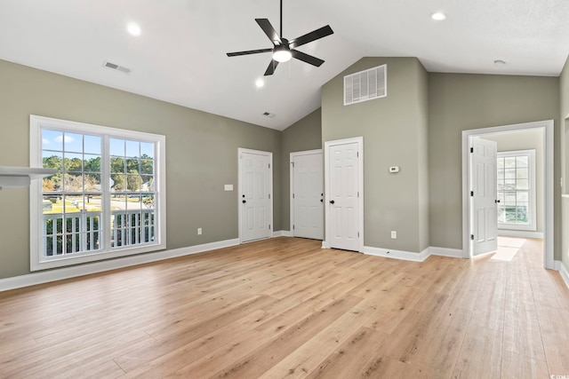 interior space featuring plenty of natural light, high vaulted ceiling, and light hardwood / wood-style flooring