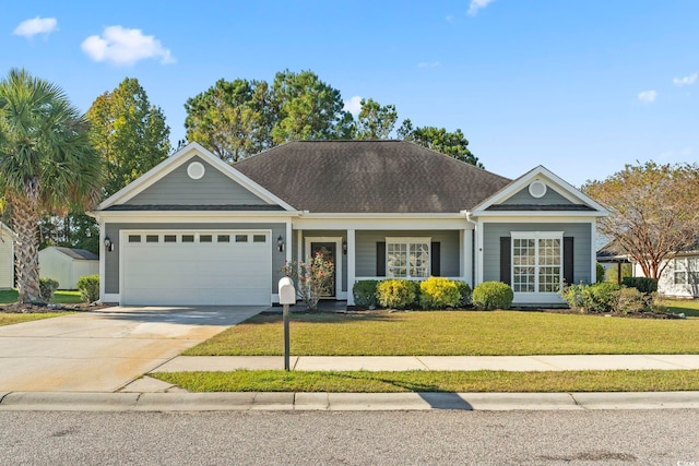 view of front of property featuring a garage and a front yard