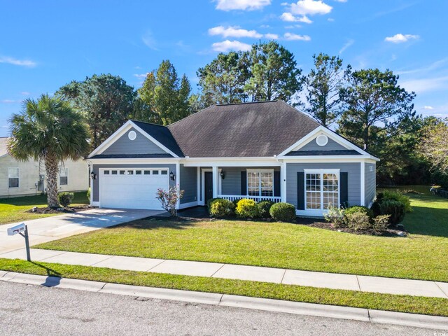 single story home with covered porch, a front yard, and a garage