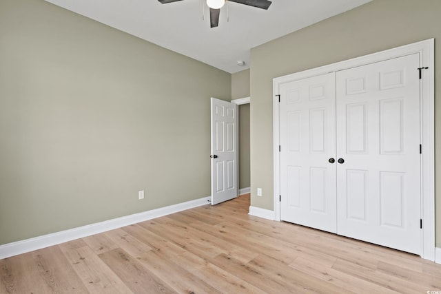 unfurnished bedroom with ceiling fan, a closet, and light hardwood / wood-style floors