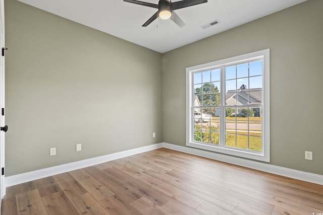 unfurnished room with light wood-type flooring and ceiling fan