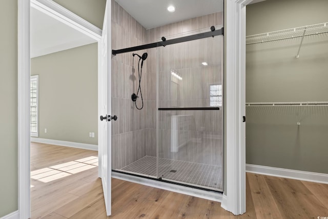 bathroom featuring hardwood / wood-style floors and a shower with door