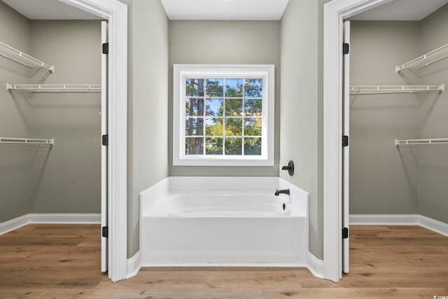 bathroom featuring hardwood / wood-style flooring and a tub