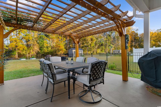 view of patio featuring a storage shed, a pergola, and grilling area