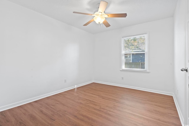 spare room featuring light wood-type flooring and ceiling fan