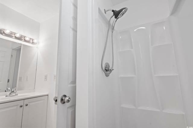 bathroom with a shower and vanity