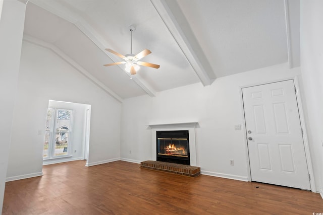 unfurnished living room featuring hardwood / wood-style flooring, vaulted ceiling with beams, ceiling fan, and a fireplace