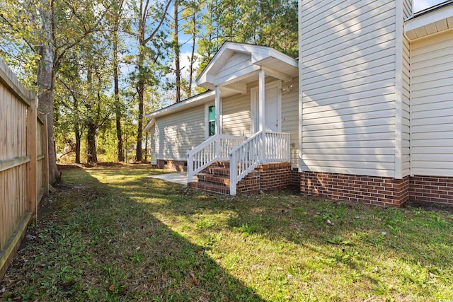 view of exterior entry with a lawn