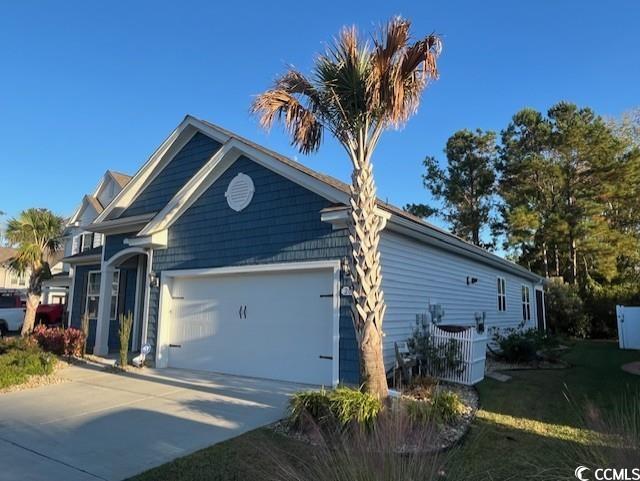 view of home's exterior featuring a garage and central air condition unit