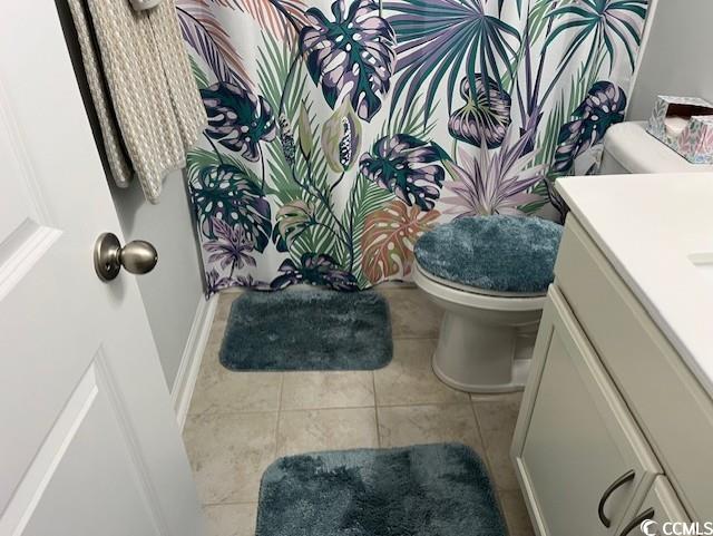 bathroom featuring tile patterned flooring, vanity, and toilet